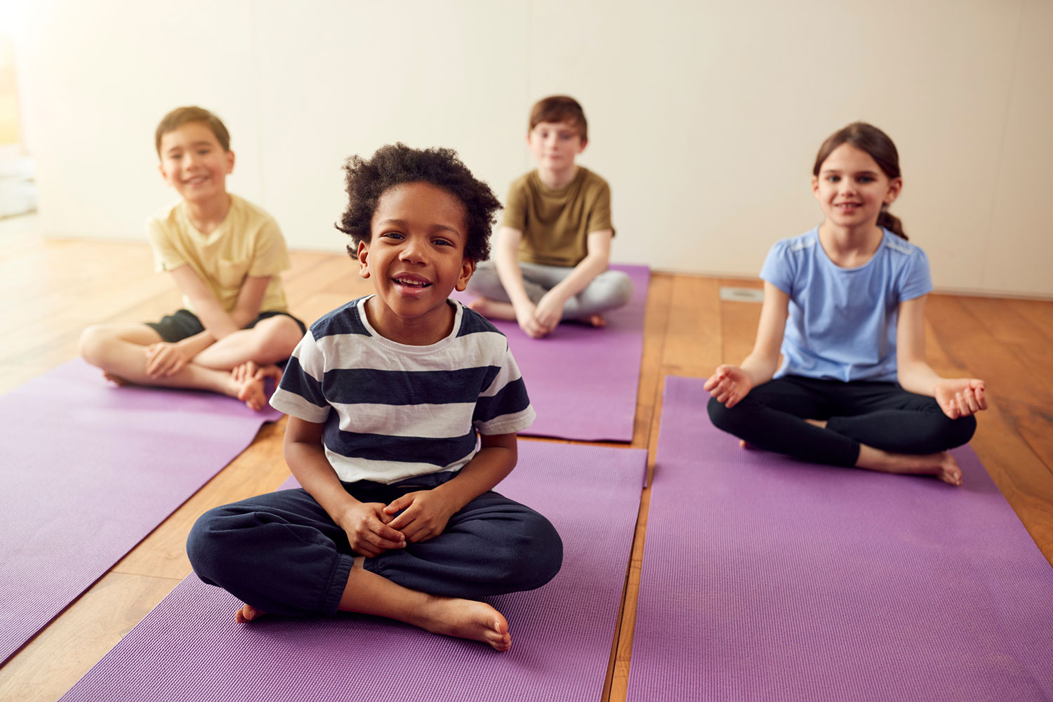 smiling kids on yoga mats